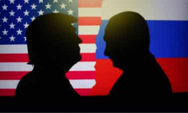 Silhouettes of Donald Trump vs Vladimir Putin facing each other with the flags of the United States and Russia in the background